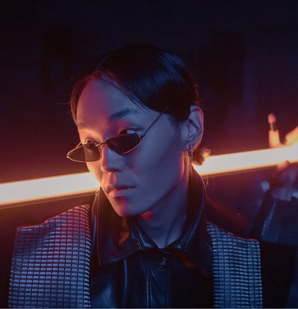 Futuristic-style photo of a person wearing sunglasses and leather jacket